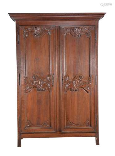 A Louis XV carved walnut two door press cupboard