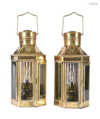 A pair of brass and glazed wall lights in the manner of maritime lanterns