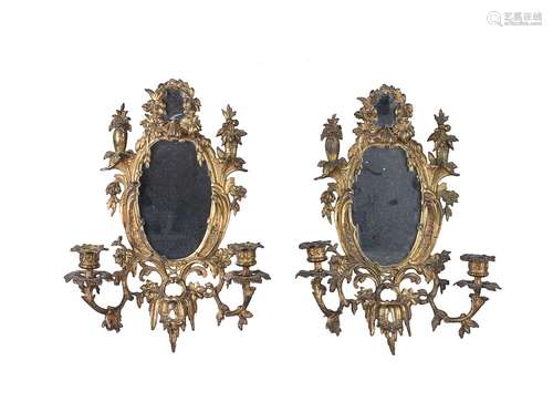 A pair of gilt metal twin light girandoles in Rococo taste