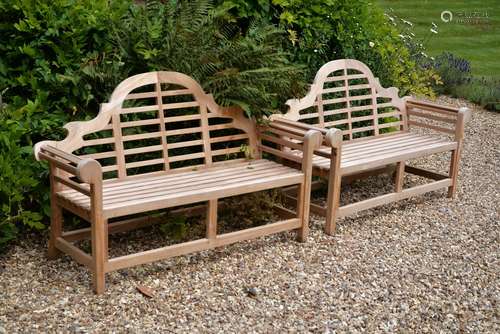 A pair of teak garden benches