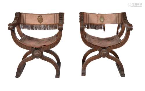 A pair of walnut and silk upholstered X-framed chairs, in 17th century style