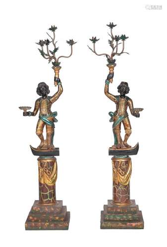 A pair of carved, painted, ebonised, and parcel gilt wood blackamoor torcheres