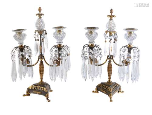 A pair of patinated and parcel gilt bronze and cut glass mounted twin light lustre candelabra in Reg