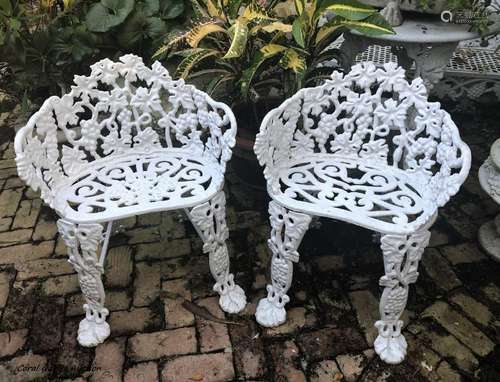 Two white cast iron patio chairs