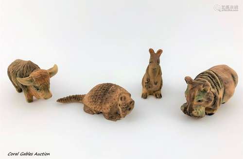 Set of four miniature animals carved in wood. Signed