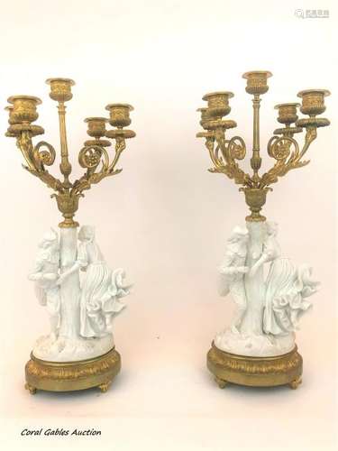 Pair of biscuit and bronze candlesticks.