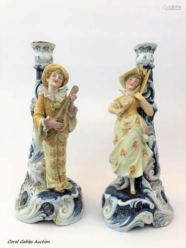 Pair of porcelain and biscuit candlesticks.