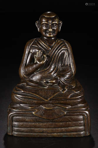 A BRONZE CHARACTER  SITTING STYLE FIGURE