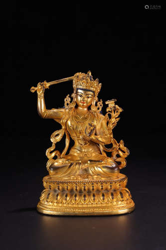 A GILT BRONZE BUDDHA SHAPED ORNAMENT