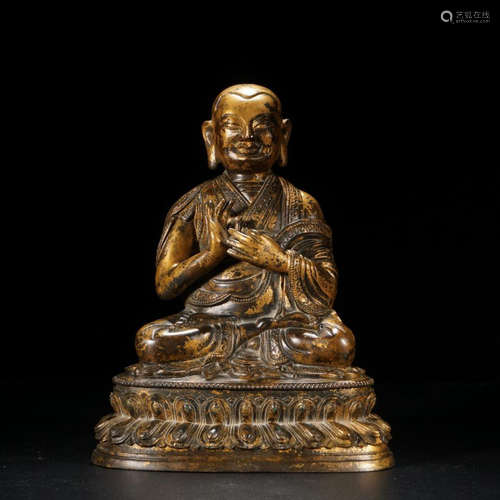 A GILT BRONZE BUDDHA ORNAMENT