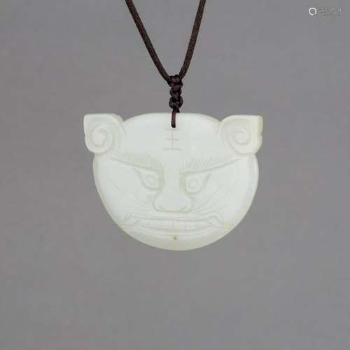 A WHITE JADE TIGER HEAD PENDANT, MID-QING PERIOD