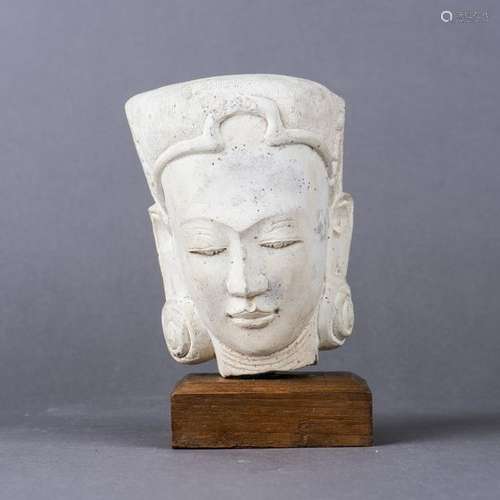 A NEPALESE CLAY BUDDHA HEAD ON WOOD BASE