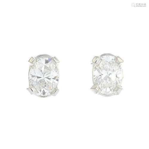 A pair of 18ct gold oval-shape diamond stud earrings.