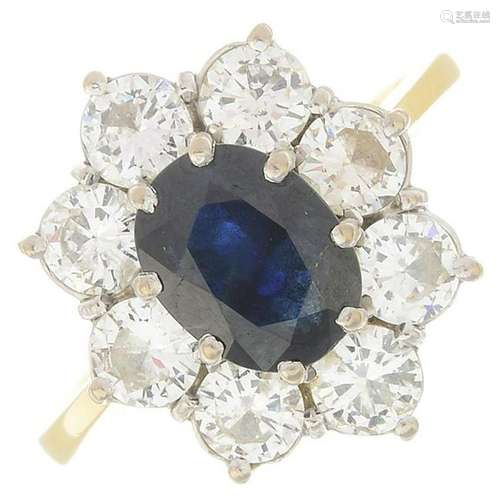 An 18ct gold sapphire and diamond cluster ring.Sapphire