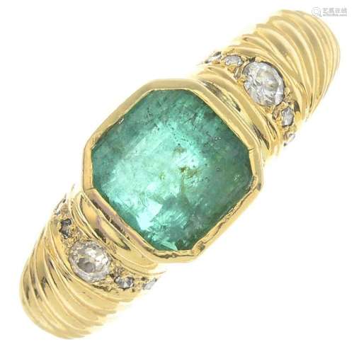 An emerald and diamond dress ring. Emerald calculated