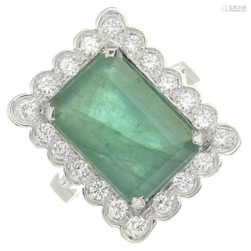 An emerald and diamond cluster ring.Emerald calculated