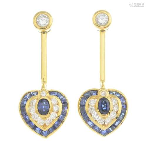 A pair of sapphire and diamond earrings.Total sapphire