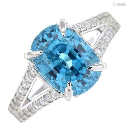 A blue zircon and diamond dress ring.Zircon calculated