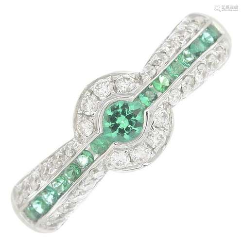 An emerald and diamond dress ring.Total emerald weight