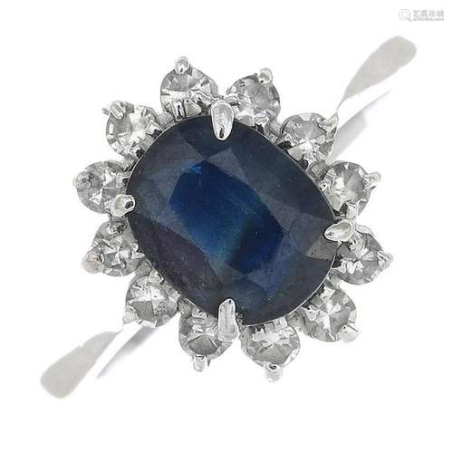 A cluster ring, set with sapphire and diamonds.Sapphire