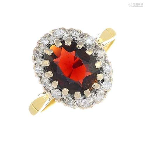 An 18ct gold garnet and diamond cluster ring. Estimated