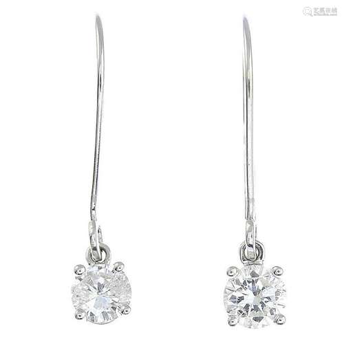 A pair of diamond earrings.Estimated total diamond