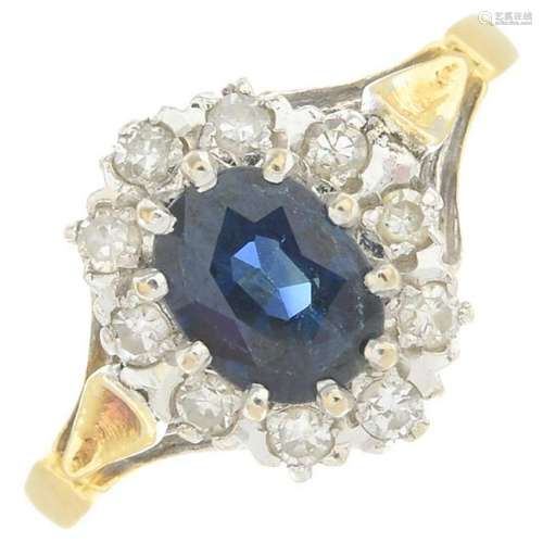 An 18ct gold sapphire and diamond cluster ring.Sapphire