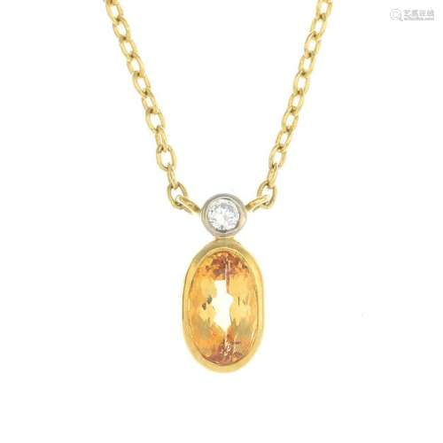 An 18ct gold topaz and diamond pendant, suspended from
