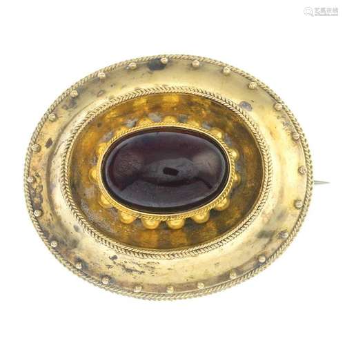 A late Victorian gold garnet brooch.Length 4.1cms.