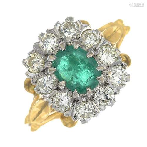 An 18ct gold emerald and diamond cluster ring.Emerald