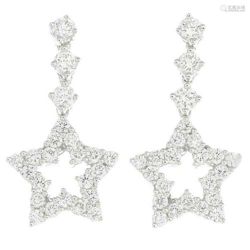 A pair of diamond star earrings.Diamond weight