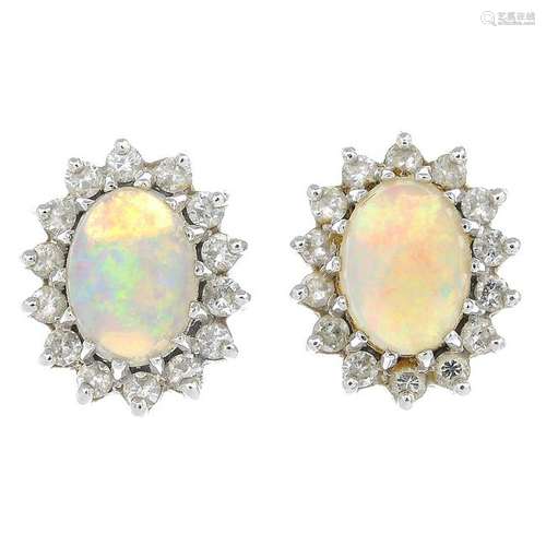 A pair of 18ct gold opal and diamond cluster earrings.