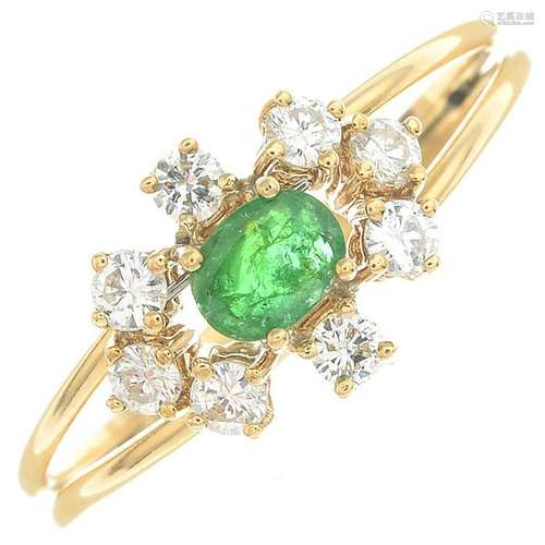 An emerald and diamond cluster ring.Estimated total