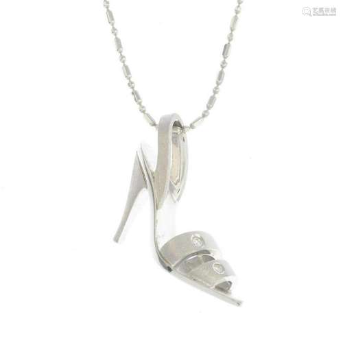 An 18ct gold diamond shoe pendant, suspended from a