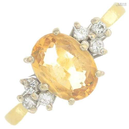 An 18ct gold yellow topaz and diamond dress ring. Topaz