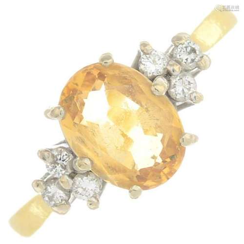An 18ct gold yellow topaz and diamond dress ring. Topaz