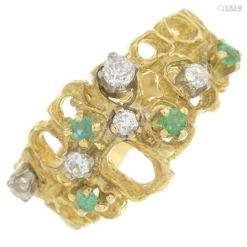 An 18ct gold emerald and diamond dress ring.Estimated