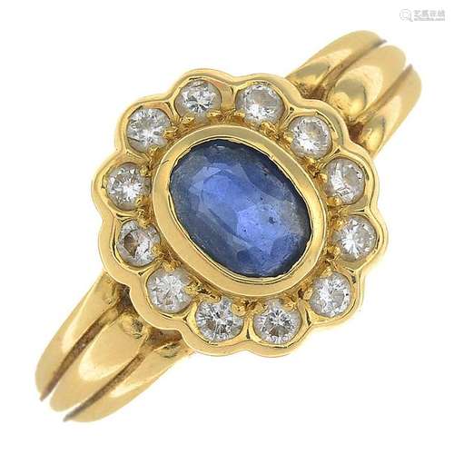 An 18ct gold sapphire and diamond cluster ring.Sapphire