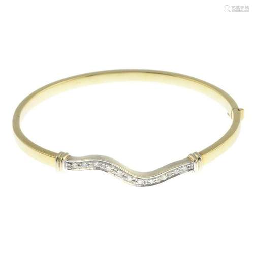 A diamond bangle.Estimated total diamond weight 0.30ct.