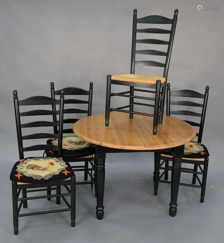 A five piece set to include a round pine table and four