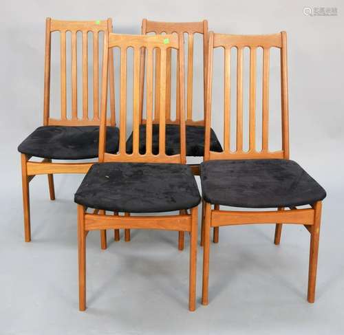 Set of four slat back Scandinavian teak dining chairs.