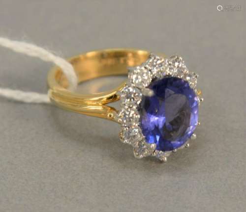 18K gold ring set with oval center Tanzanite surrounded