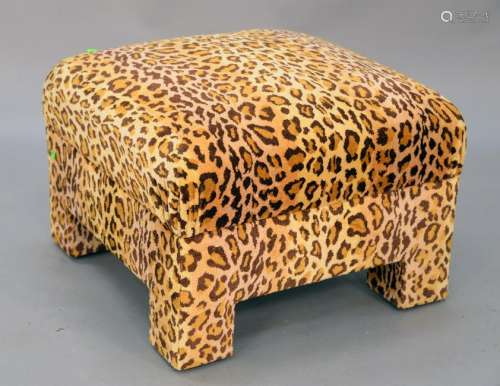 Custom upholstered footstool in leopard print, possibly