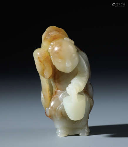 A Fine Chinese White and Russet Jade Carving of A Boy In Deerskin