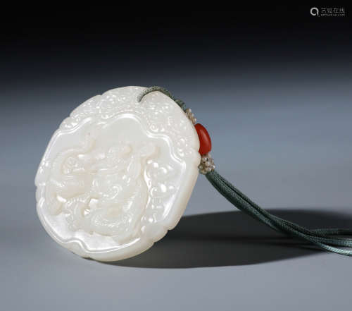 A Rare Chinese Carved White Jade Pendent of A Boy Riding Dragon