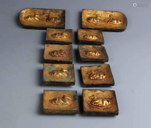 A Set of Eight Chinese Gilt-Bronze Belt Buckles