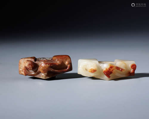 Two Chinese Carved Archaistic White and Russet Jade Sword Slides