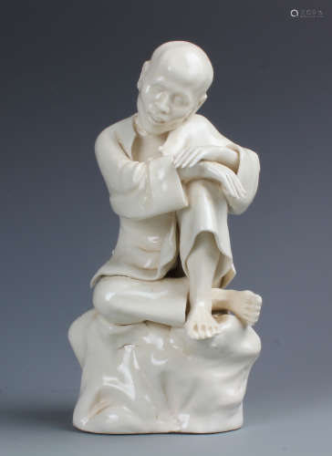 A Carved White Porcelain Figurine, Reign of Dehua