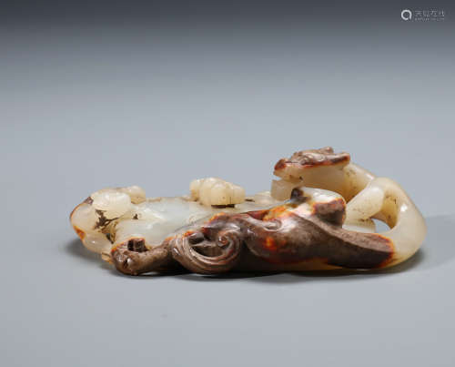 A Finely Carved Chinese White and Russet Jade Chilong Bi