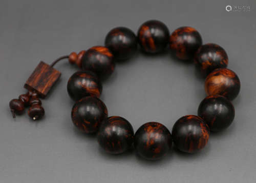 A Chinese Carved Huanghuali Bracelet